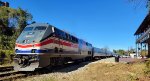 AMTK 160 on train 151 sits behind Kemper Street Station